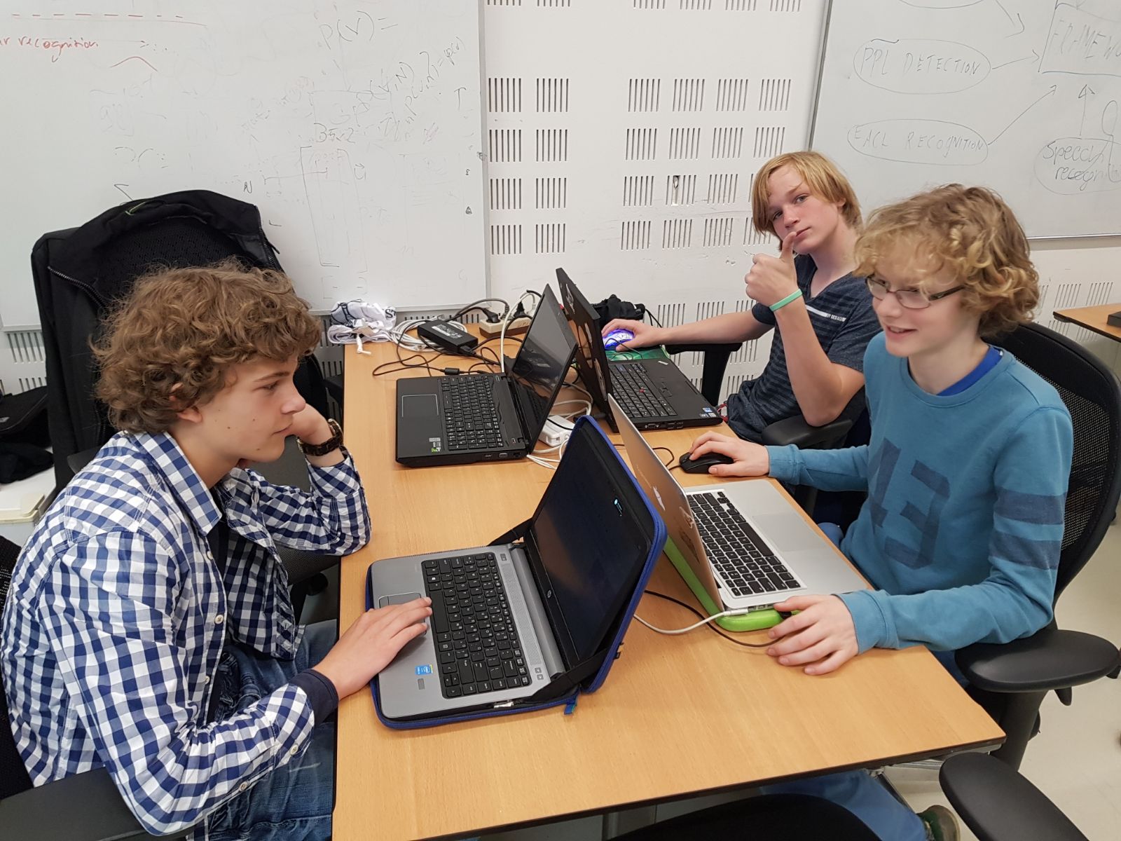 Part of the team sitting around the table learning pepper programming